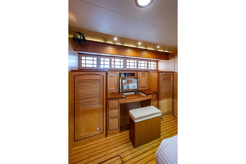 Ben's Barge Yacht Photos Pics Luxurious wooden interior of 2014 Marlow Explorer 66E yacht with desk and seating.