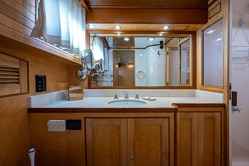 Ben's Barge Yacht Photos Pics Luxurious bathroom interior of 2014 Marlow Explorer 66E yacht with wooden cabinetry and modern fixtures.