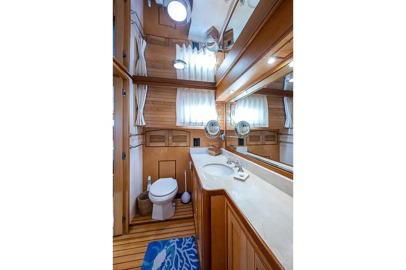 Ben's Barge Yacht Photos Pics Luxurious bathroom in 2014 Marlow Explorer 66E yacht with wooden accents and modern fixtures.