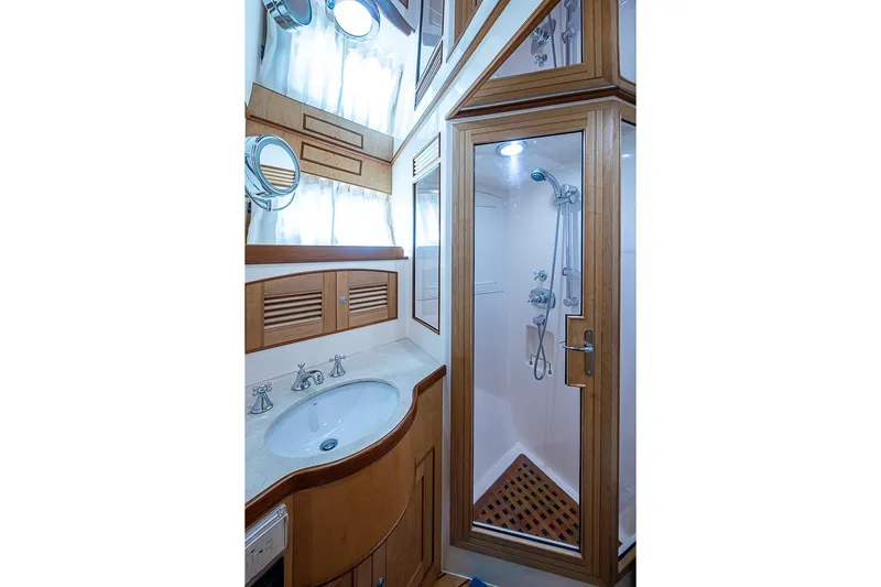 Ben's Barge Yacht Photos Pics Luxurious bathroom in 2014 Marlow Explorer 66E yacht with wood accents and glass shower.