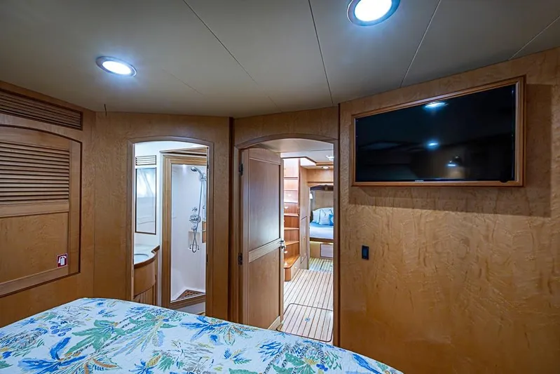 Ben's Barge Yacht Photos Pics Luxurious cabin interior of 2014 Marlow Explorer 66E yacht with TV and ensuite bathroom.