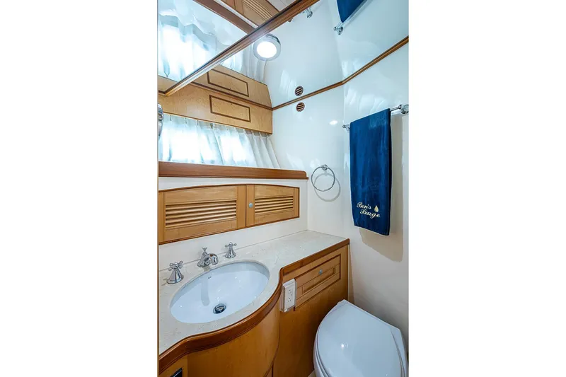 Ben's Barge Yacht Photos Pics Luxurious bathroom in 2014 Marlow Explorer 66E yacht with elegant wood cabinetry.