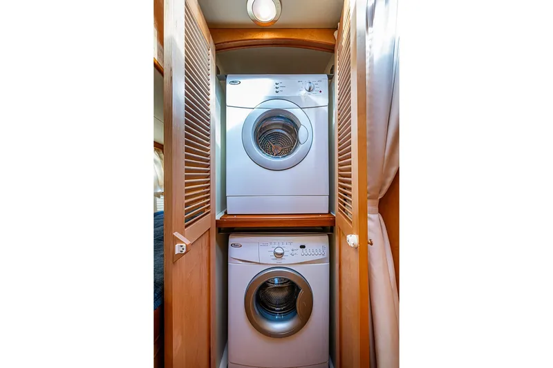 Ben's Barge Yacht Photos Pics Stacked washer and dryer in 2014 Marlow Explorer 66E yacht laundry area.