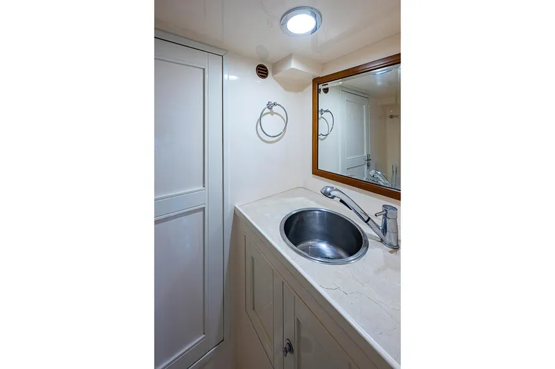 Ben's Barge Yacht Photos Pics Bathroom interior of 2014 Marlow Explorer 66E yacht with sink and mirror.