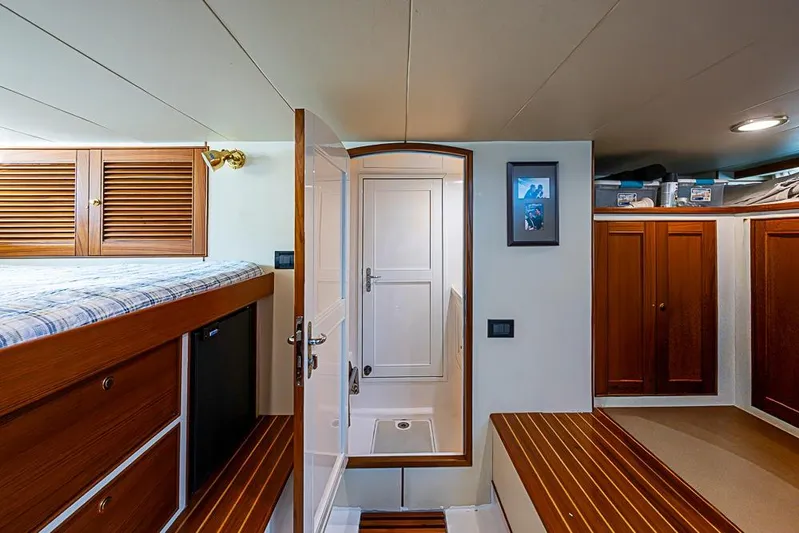 Ben's Barge Yacht Photos Pics Interior of 2014 Marlow Explorer 66E yacht with wooden cabinetry and cozy sleeping area.
