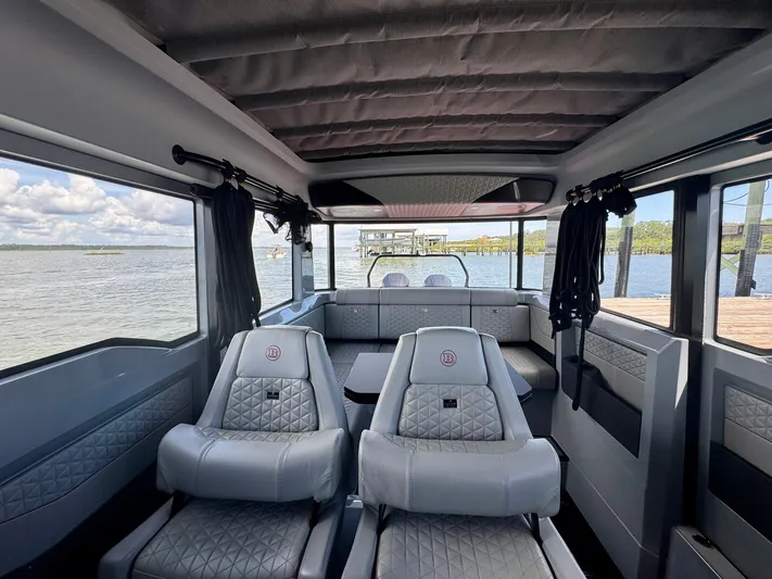  Yacht Photos Pics Interior of 2023 Axopar Shadow 900XC boat with luxurious seating and panoramic windows.