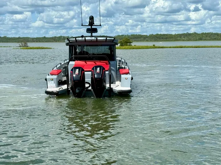  Yacht Photos Pics 2023 Axopar Shadow 900XC boat on water, featuring dual engines and sleek design.