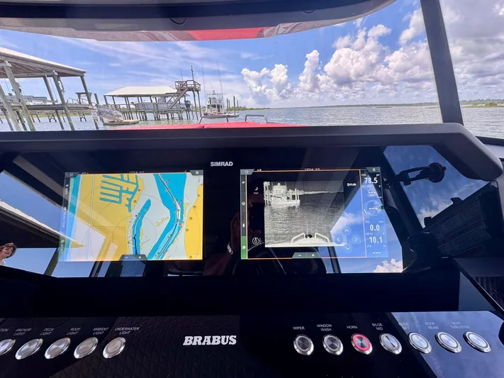  Yacht Photos Pics 2023 Axopar Shadow 900XC dashboard with navigation screens, dock view, and Brabus controls.