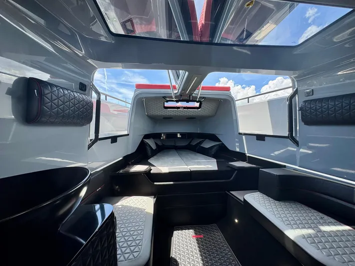  Yacht Photos Pics 2023 Axopar Shadow 900XC cabin interior with modern design and panoramic windows.