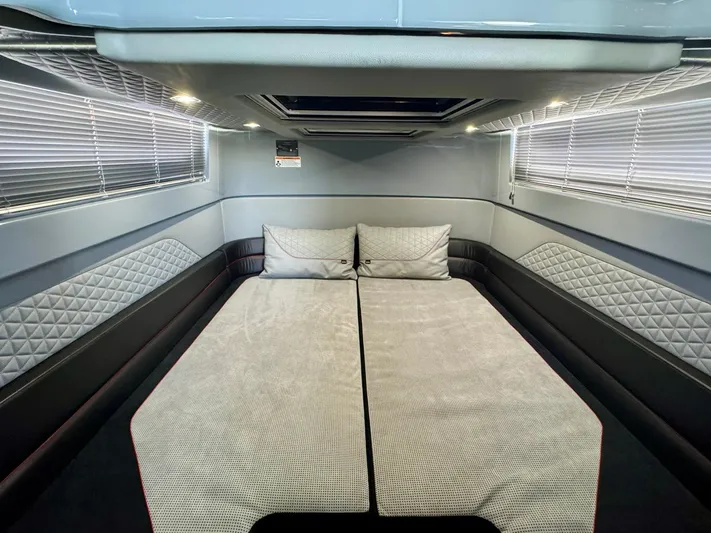  Yacht Photos Pics 2023 Axopar Shadow 900XC cabin interior with modern bedding and sleek design.