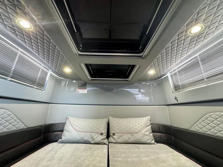  Yacht Photos Pics Luxurious interior cabin of 2023 Axopar Shadow 900XC with quilted upholstery and skylight.