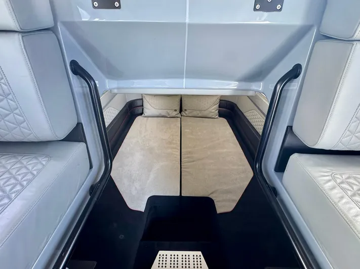  Yacht Photos Pics 2023 Axopar Shadow 900XC interior cabin with cushioned seating and modern design.