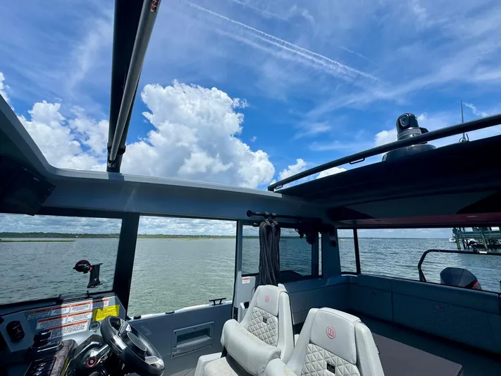  Yacht Photos Pics 2023 Axopar Shadow 900XC boat interior with panoramic water view and blue sky.