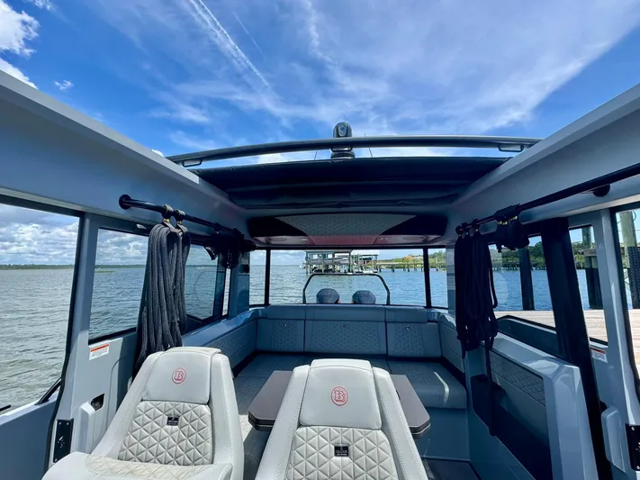  Yacht Photos Pics 2023 Axopar Shadow 900XC interior with luxurious seating and panoramic water view.