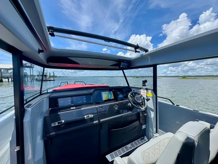  Yacht Photos Pics 2023 Axopar Shadow 900XC boat interior with panoramic views and modern dashboard.