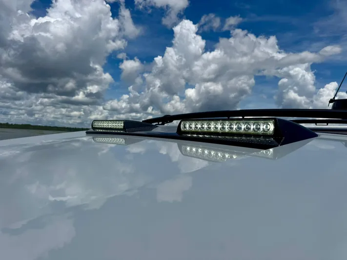  Yacht Photos Pics 2023 Axopar Shadow 900XC LED lights under a cloudy sky.