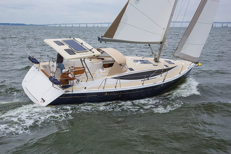 Nymph Yacht Photos Pics 2014 Marlow-Hunter 40 sailboat navigating open waters with bridge in background.