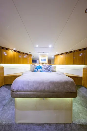  Yacht Photos Pics Luxurious bedroom in a 2001 Hatteras 60 enclosed bridge yacht.