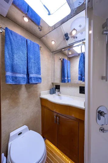  Yacht Photos Pics 2001 Hatteras 60 Enclosed Bridge yacht bathroom with blue towels and modern fixtures.