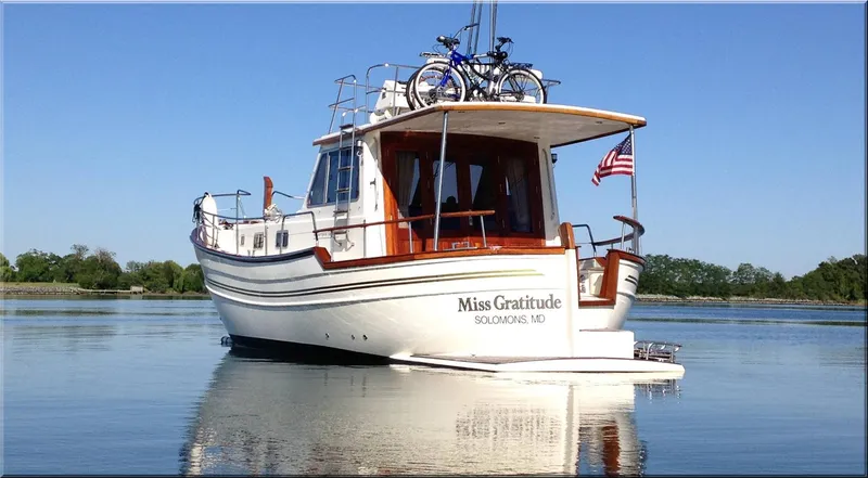  Yacht Photos Pics 2004 Menorquin 120 boat named "Miss Gratitude" on calm water with bicycles on deck.