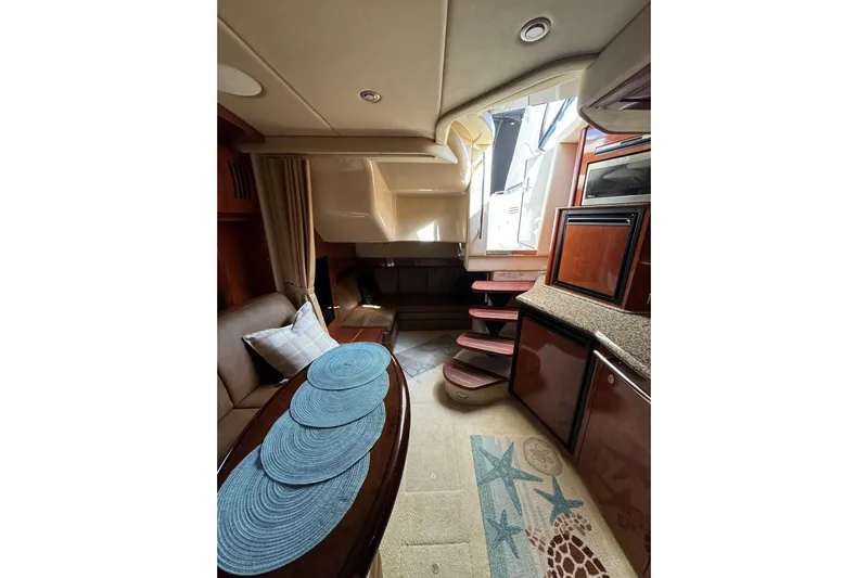  Yacht Photos Pics Interior of 2006 Sea Ray 38 Sundancer yacht with elegant wood finishes and cozy seating.