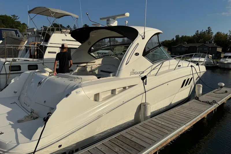  Yacht Photos Pics 2006 Sea Ray 38 Sundancer yacht docked at marina, featuring sleek design and spacious deck.