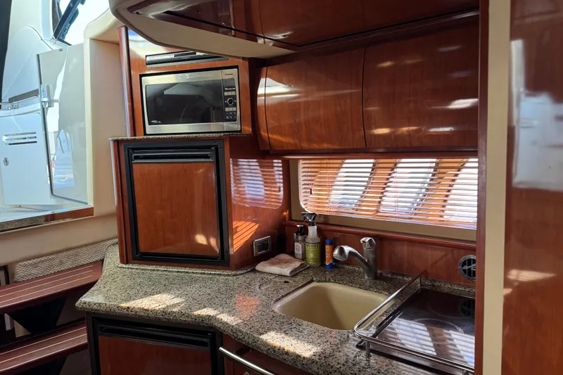  Yacht Photos Pics Luxurious 2006 Sea Ray 38 Sundancer yacht kitchen with wood cabinetry and granite countertops.