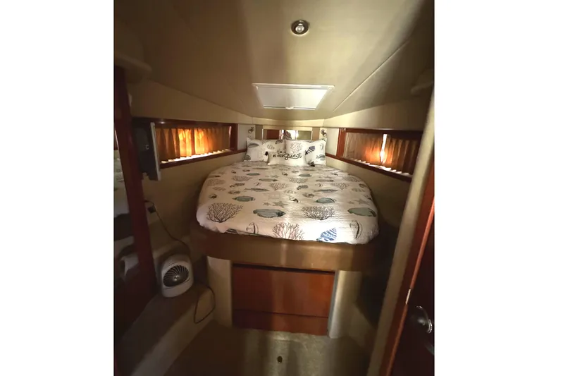  Yacht Photos Pics Interior cabin of 2006 Sea Ray 38 Sundancer with cozy bed and nautical decor.