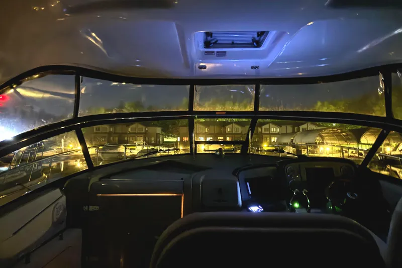  Yacht Photos Pics Interior view of 2006 Sea Ray 38 Sundancer yacht at night, docked with illuminated dashboard.