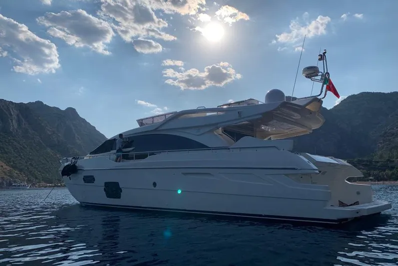  Yacht Photos Pics 2013 Ferretti Yachts 690 on serene water with mountainous backdrop and bright sky.
