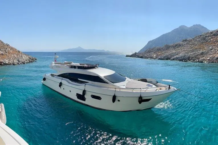  Yacht Photos Pics 2013 Ferretti Yachts 690 in clear blue waters near rocky coastline.