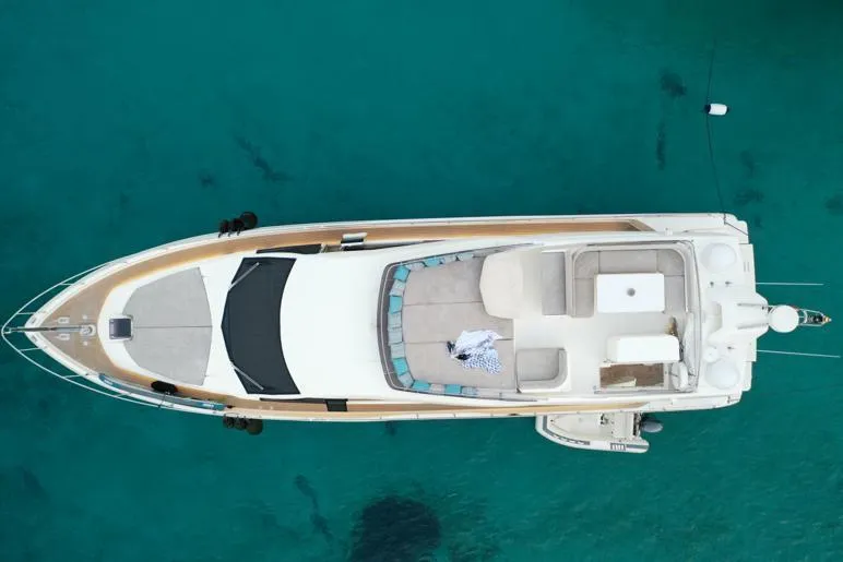  Yacht Photos Pics Aerial view of 2013 Ferretti Yachts 690 on clear turquoise water.