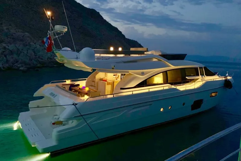  Yacht Photos Pics Luxurious 2013 Ferretti Yachts 690 illuminated at night, anchored in serene waters.