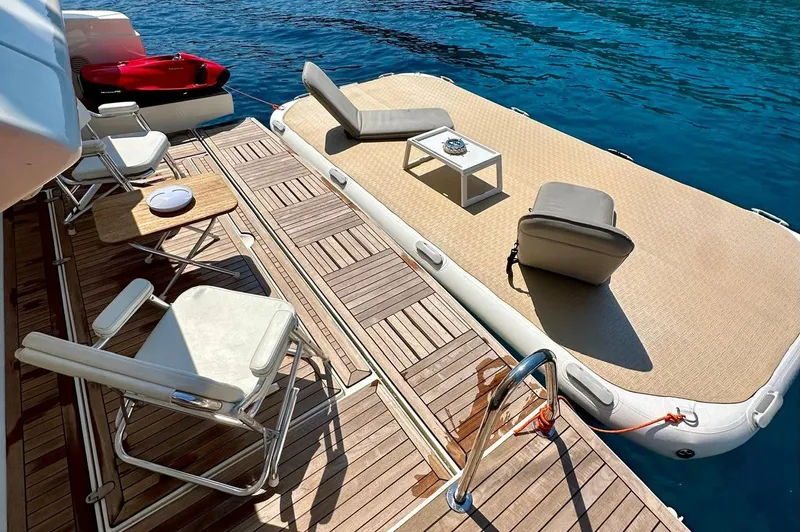  Yacht Photos Pics Luxurious Ferretti Yachts 690 deck with chairs and floating platform, 2013 model.