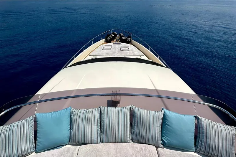  Yacht Photos Pics 2013 Ferretti Yachts 690 bow view with cushions, sailing on calm blue sea.
