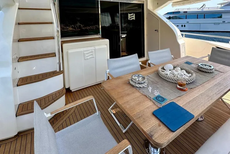  Yacht Photos Pics Luxurious 2013 Ferretti Yachts 690 deck with elegant dining setup and modern design.