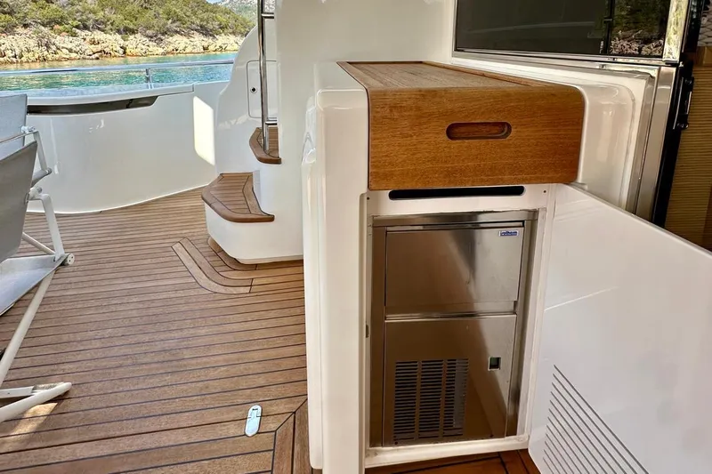  Yacht Photos Pics Luxurious 2013 Ferretti Yachts 690 deck with wooden flooring and built-in storage.