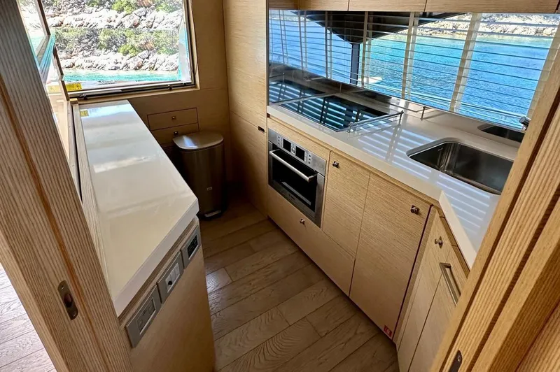  Yacht Photos Pics Modern kitchen interior on a 2013 Ferretti Yachts 690, featuring sleek cabinetry and ocean view.