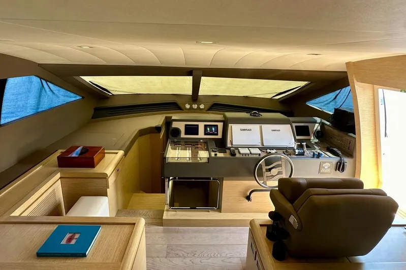  Yacht Photos Pics Interior helm of 2013 Ferretti Yachts 690, featuring modern navigation equipment and luxurious seating.