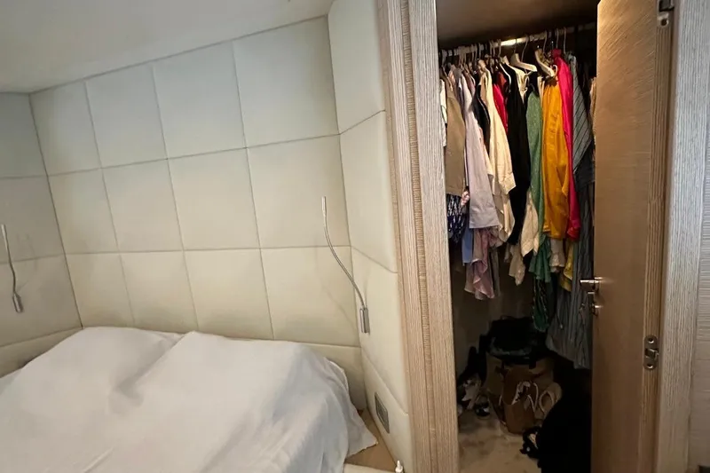  Yacht Photos Pics Bedroom and closet interior of 2013 Ferretti Yachts 690, featuring modern design and ample storage.