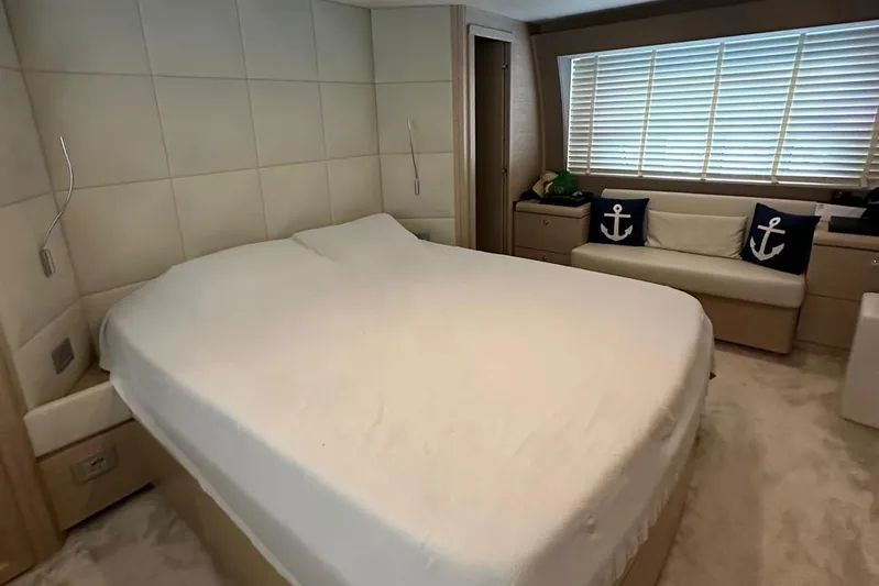  Yacht Photos Pics Luxurious bedroom in 2013 Ferretti Yachts 690, featuring a large bed and nautical decor.