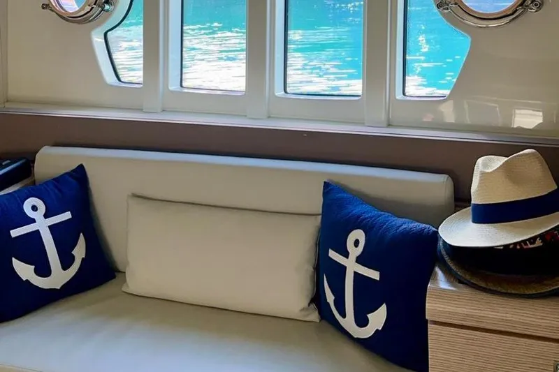 Yacht Photos Pics Interior of 2013 Ferretti Yachts 690 with nautical-themed cushions and hats.