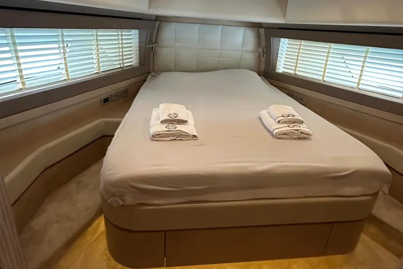  Yacht Photos Pics Luxurious bedroom interior of 2013 Ferretti Yachts 690 with neatly arranged towels.