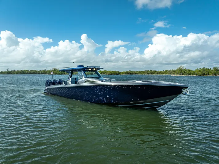  Yacht Photos Pics 2024 Nor-Tech 450 Sport Center Console boat on calm water under blue sky.