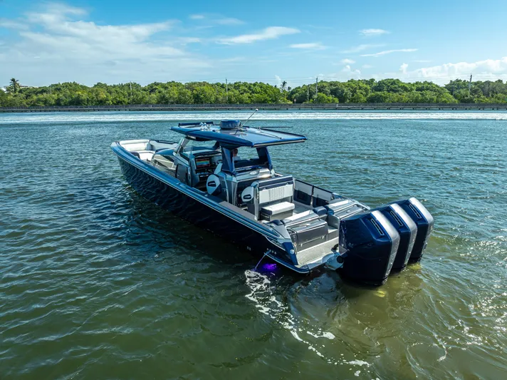  Yacht Photos Pics 2024 Nor-Tech 450 Sport Center Console boat on water, featuring triple engines.