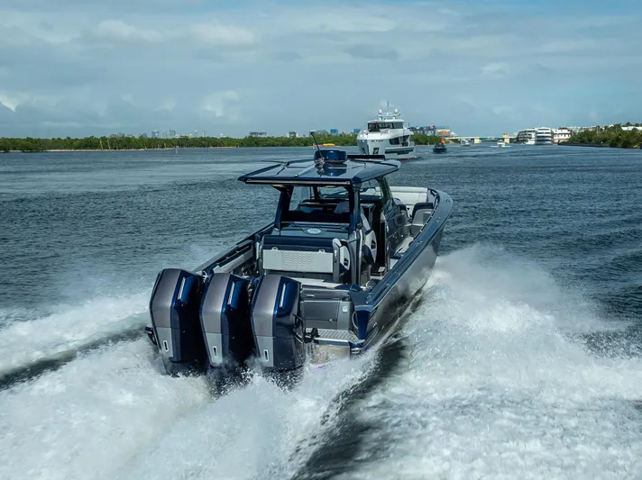  Yacht Photos Pics 2024 Nor-Tech 450 Sport Center Console cruising on open water, showcasing powerful engines.