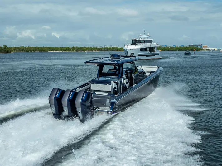  Yacht Photos Pics 2024 Nor-Tech 450 Sport Center Console speeding on water with powerful engines.
