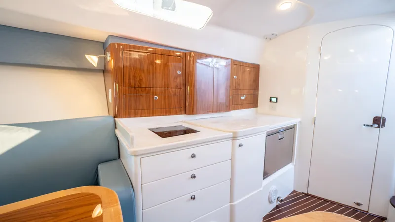  Yacht Photos Pics 2018 Intrepid 430 Sport Yacht interior with sleek cabinetry and modern kitchen amenities.