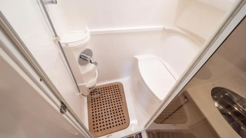  Yacht Photos Pics 2018 Intrepid 430 Sport Yacht bathroom with shower and wooden floor mat.