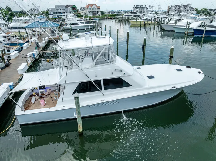 Second Chance Yacht Photos Pics A 1995 Viking 50 yacht docked in a marina with surrounding boats.